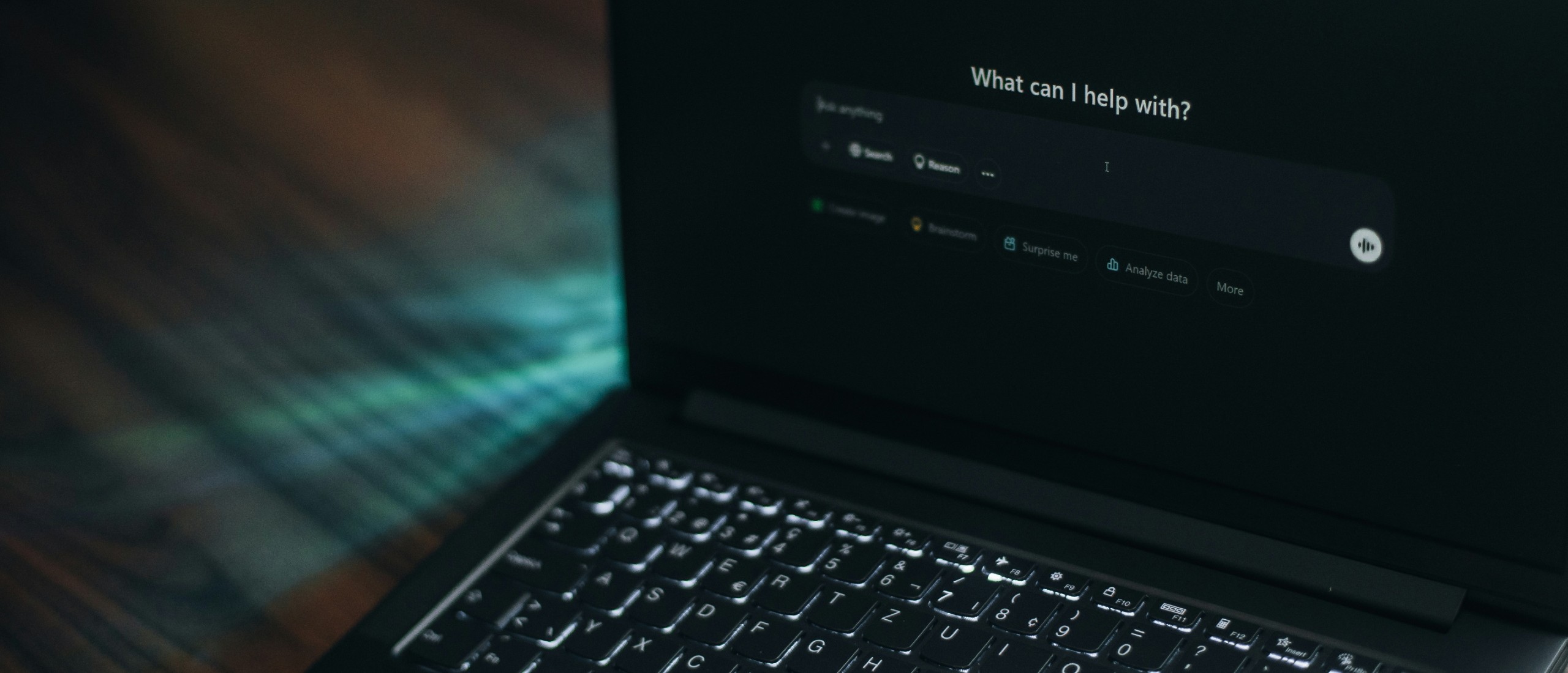 A laptop displays an AI search bar.
